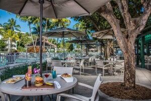 A breakfast setting on an outdoor patio with a water view.